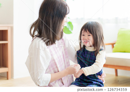 Nursery teacher playing with girls 126734359