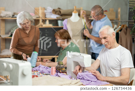 Group of elderly people at sewing master class Group of elderly people at sewing master class 126734436