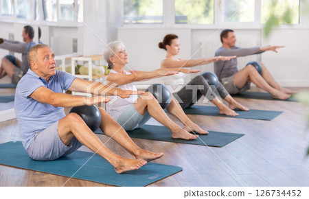 Elderly man doing pilates with softball 126734452