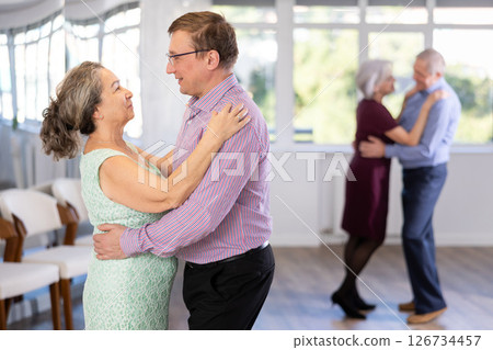 Adult man and elderly woman dance waltz Adult man and elderly woman dance waltz 126734457