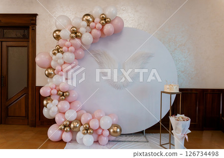Elegant Angel-Themed Baby Shower Backdrop with Pink and Gold Balloon Garland and Feather Decoration for a Special Celebration 126734498