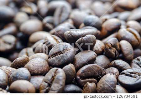 Close up view roasted coffee beans that highlights the texture and surface details of the coffee beans with customizable space for text Close up view roasted coffee beans that highlights the texture and surface details of the coffee beans with customizable space for text 126734581