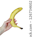 Banana held in hand against white background, ripe yellow fruit, healthy food, isolated on transparent background 126734602