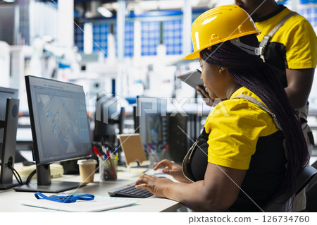 Technicians in photovoltaics factory reviewing solar panels assembly lines, reading industrial guidelines and ensuring seamless production. All black team optimizing the solar cell activity. 126734760
