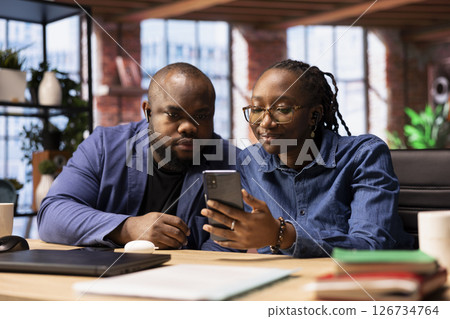 African american couple at home office participating in a teleconference for remote workshop, maintaining a strong digital connection for an effective online course. Virtual call. African american couple at home office participating in a teleconference for remote workshop, maintaining a strong digital connection for an effective online course. Virtual call. 126734764