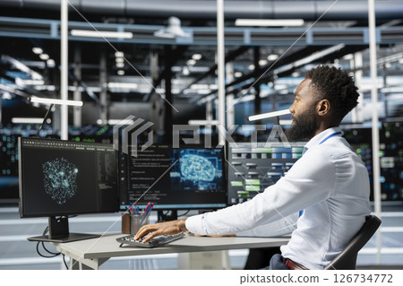 Data center engineer using machine learning algorithms on computer to analyze vast datasets to recognize emerging trends and predict future patterns based on historical data 126734772
