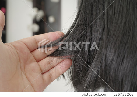 Woman's hair being treated at a beauty salon Woman's hair being treated at a beauty salon 126735205
