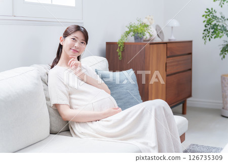Thinking young pregnant woman Thinking young pregnant woman 126735309