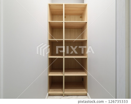 A Simple Wooden Shelf Unit featuring Compartments designed specifically for Storage purposes 126735333