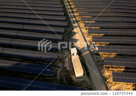 Solar farm with rows of dark solar panels arranged 126735343
