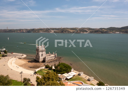 Belem Tower on Tagus River with boats creating 126735349
