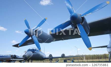 Vintage Aircraft With Blue Propellers Displayed Outdoors Against a Clear Sky at an Aviation Museum on a Sunny Day 126735861