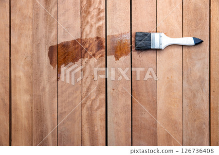 Paint brush and wood material in construction work. 126736408