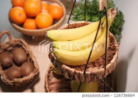 Fresh fruit display with bananas and oranges in market 126736664