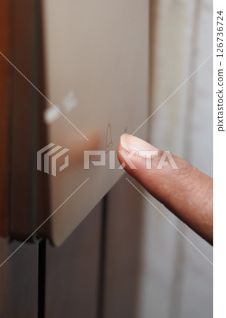 Finger pressing a button on a sleek control panel 126736724