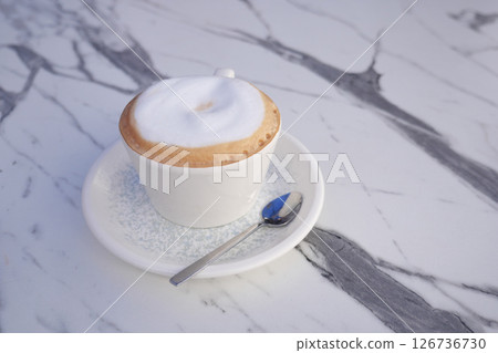 Delicious cappuccino served in a cozy cafe setting 126736730