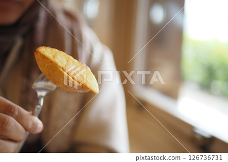 Fork with a tasty baked potato slice 126736731