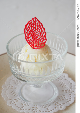 Delicate dessert served in a crystal dish with a red garnish Delicate dessert served in a crystal dish with a red garnish 126736746