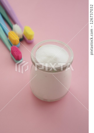 baking soda and tooth brush on pink background  126737032