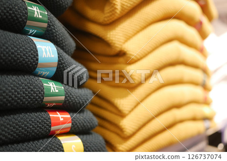 Colorful sweaters arranged neatly in retail display Colorful sweaters arranged neatly in retail display 126737074