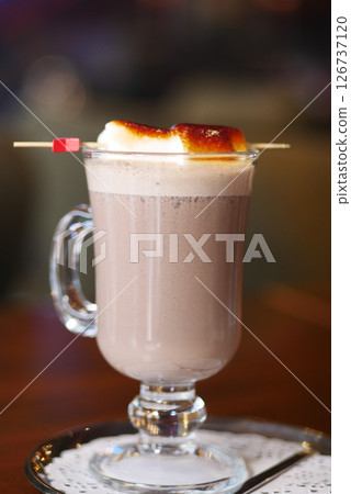 Warm chocolate drink topped with caramel and marshmallow Warm chocolate drink topped with caramel and marshmallow 126737120