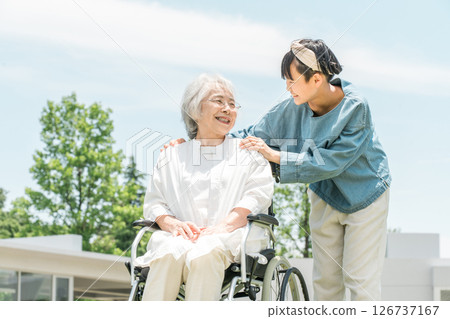 Senior woman in a wheelchair, grandmother and granddaughter visiting 126737167