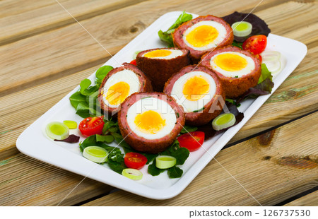 Scotch eggs with vegetable salad 126737530