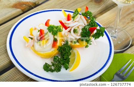 Salad with squids, cucumbers, bell pepper in lemon with wine 126737774