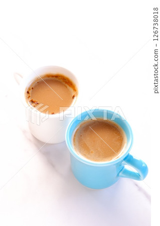 Two mugs filled with caffe latte, a coffee made from espresso and milk 126738018