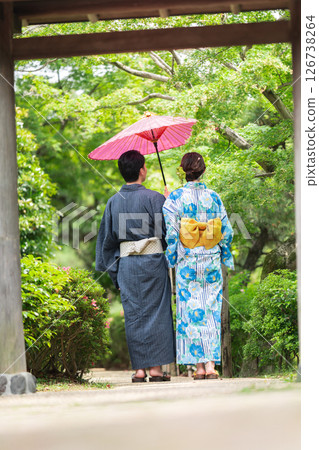 A couple in yukata walking through a Japanese garden A couple in yukata walking through a Japanese garden 126738264