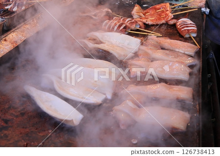 A large grilled squid stall. Steaming grilled squid 126738413