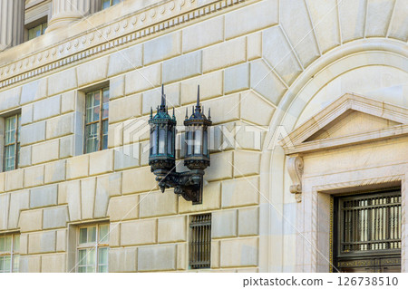 Ornate lanterns adorn exterior of historic building, highlighting its architectural design at Washington D.C Ornate lanterns adorn exterior of historic building, highlighting its architectural design at Washington D.C 126738510