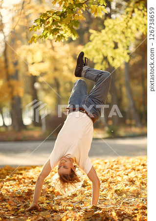 Stylish man dancing in park. Free space. Man in a white t-shirt. 126738659