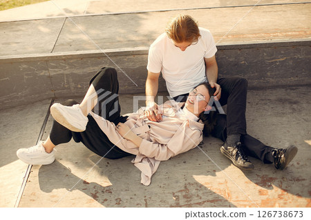 Couple in a summer park. Man in a white t-shirt. Couple in a summer park. Man in a white t-shirt. 126738673