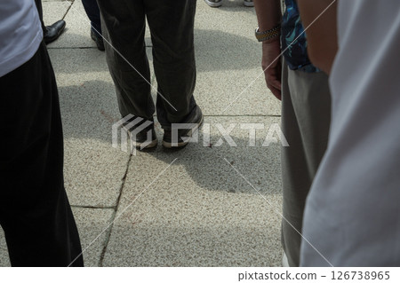 [Japan] The feet of Japanese worshippers lining the stone-paved approach to Yasukuni Shrine in Chiyoda Ward, Tokyo 126738965