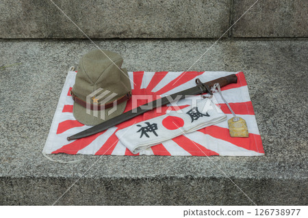 [Japan] World War II Rising Sun flag, military cap, military sword, Hinomaru flag and Kamikaze headband placed at Yasukuni Shrine in Chiyoda Ward, Tokyo 126738977