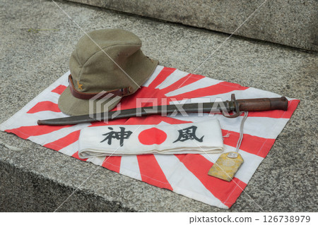 [Japan] World War II Rising Sun flag, military cap, military sword, Hinomaru flag and Kamikaze headband placed at Yasukuni Shrine in Chiyoda Ward, Tokyo 126738979