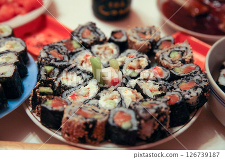 table with a set of rolls and sauce table with a set of rolls and sauce 126739187