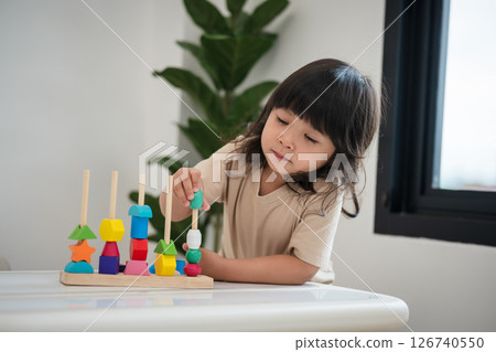 toddler girl playing educational wooden toy toddler girl playing educational wooden toy 126740550