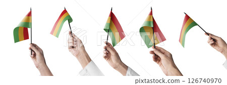 The Bolivia flag in hand in different angles on a white background The Bolivia flag in hand in different angles on a white background 126740970
