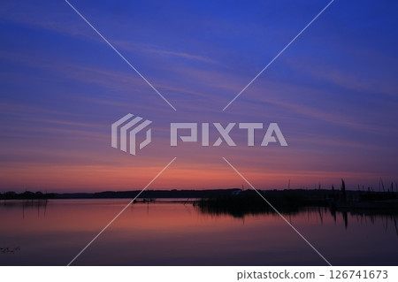 Morning glow reflected on the water surface Morning glow reflected on the water surface 126741673