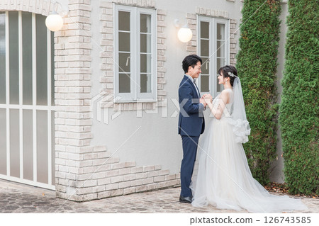 Bride and groom in the garden of the wedding venue at the wedding ceremony (Garden wedding) Bride and groom in the garden of the wedding venue at the wedding ceremony (Garden wedding) 126743585