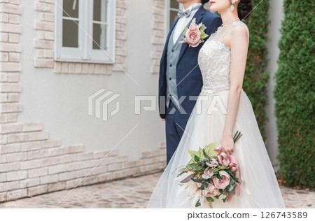 Bride and groom in the garden of a wedding venue (Garden wedding) Bride and groom in the garden of a wedding venue (Garden wedding) 126743589