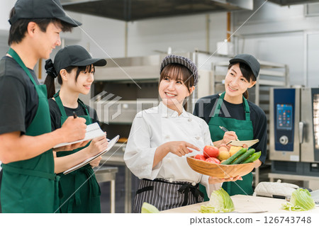 A female instructor (food coordinator/registered dietitian) who teaches at cooking seminars and study groups A female instructor (food coordinator/registered dietitian) who teaches at cooking seminars and study groups 126743748