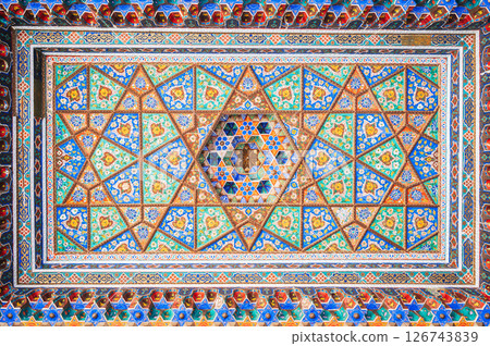 beautiful background of carved wooden painted ceiling in the Museum of Art of Uzbekistan with traditional Uzbek ornaments and colorful oriental patterns in Tashkent beautiful background of carved wooden painted ceiling in the Museum of Art of Uzbekistan with traditional Uzbek ornaments and colorful oriental patterns in Tashkent 126743839