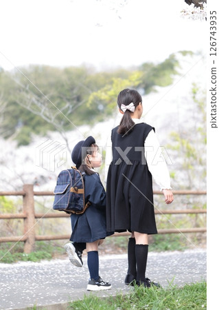 Cherry blossoms and a 3-year-old girl and her 9-year-old sister at their kindergarten entrance ceremony Cherry blossoms and a 3-year-old girl and her 9-year-old sister at their kindergarten entrance ceremony 126743935