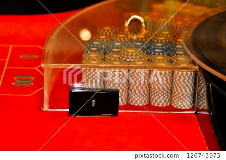 Stacks of poker chips on red poker table Stacks of poker chips on red poker table 126743973