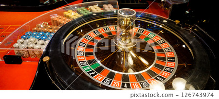 Stacks of poker chips on red poker table Stacks of poker chips on red poker table 126743974