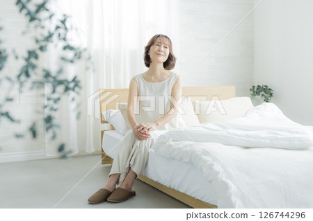 Senior woman waking up in bedroom Senior woman waking up in bedroom 126744296