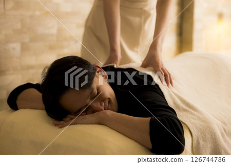Man receiving massage at beauty salon 126744786